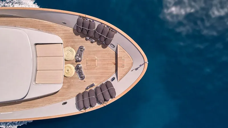 Kintaro Yacht Photos Pics Top view of 2005 Cantieri di Pisa Akhir 38 yacht on blue ocean water.