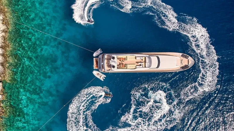 Kintaro Yacht Photos Pics Aerial view of 2005 Cantieri di Pisa Akhir 38 yacht in vibrant blue waters.