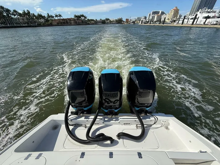  Yacht Photos Pics 2012 Midnight Express 37 Open boat with triple outboard engines cruising on a sunny day.