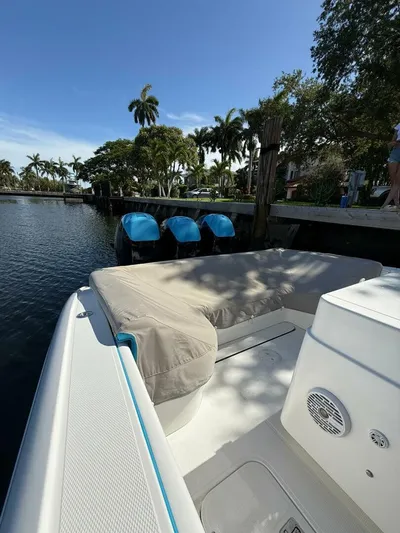  Yacht Photos Pics 2012 Midnight Express 37 Open boat docked by a scenic waterfront with palm trees.