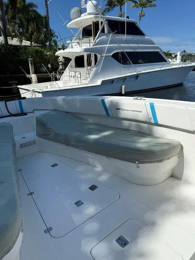  Yacht Photos Pics 2012 Midnight Express 37 Open boat interior with seating, docked near a larger yacht.