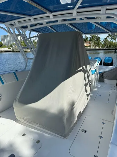  Yacht Photos Pics 2012 Midnight Express 37 Open boat interior with covered console, blue accents, and waterfront view.