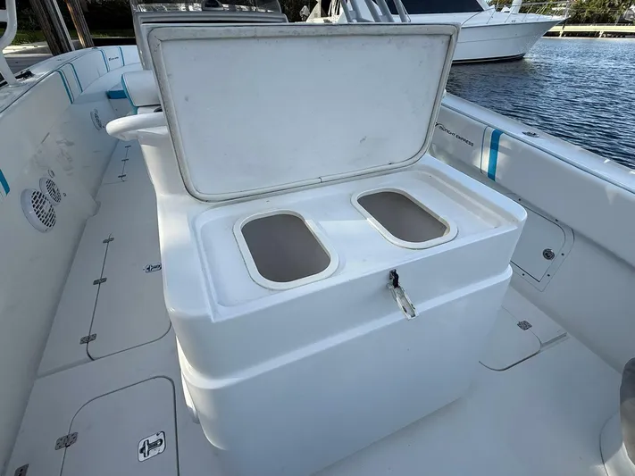  Yacht Photos Pics 2012 Midnight Express 37 Open boat interior with open storage compartment by the water.