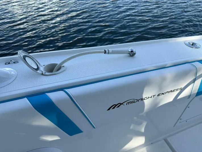  Yacht Photos Pics 2012 Midnight Express 37 Open boat detail with water hose on deck.