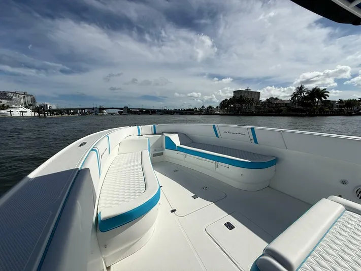  Yacht Photos Pics 2012 Midnight Express 37 Open boat with spacious seating, docked by a scenic waterfront.