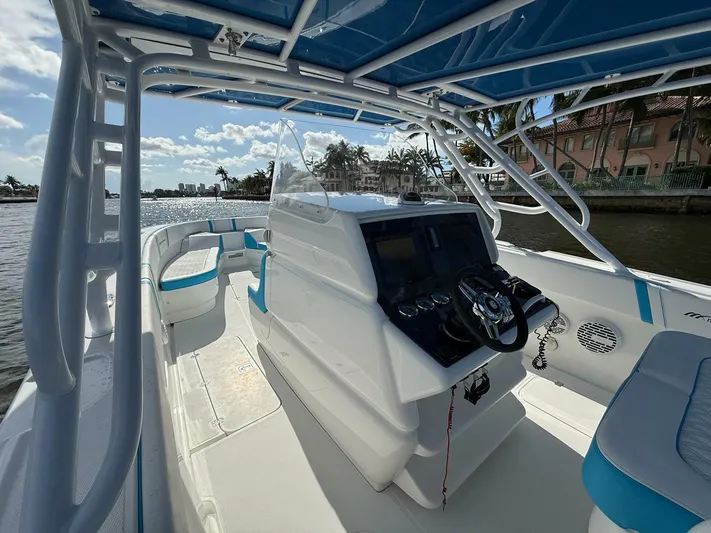  Yacht Photos Pics 2012 Midnight Express 37 Open boat interior with steering console, blue accents, and waterfront view.
