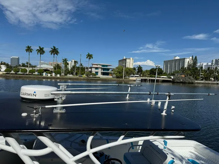 Yacht Photos Pics 2012 Midnight Express 37 Open boat with Garmin radar, docked near palm trees and buildings.