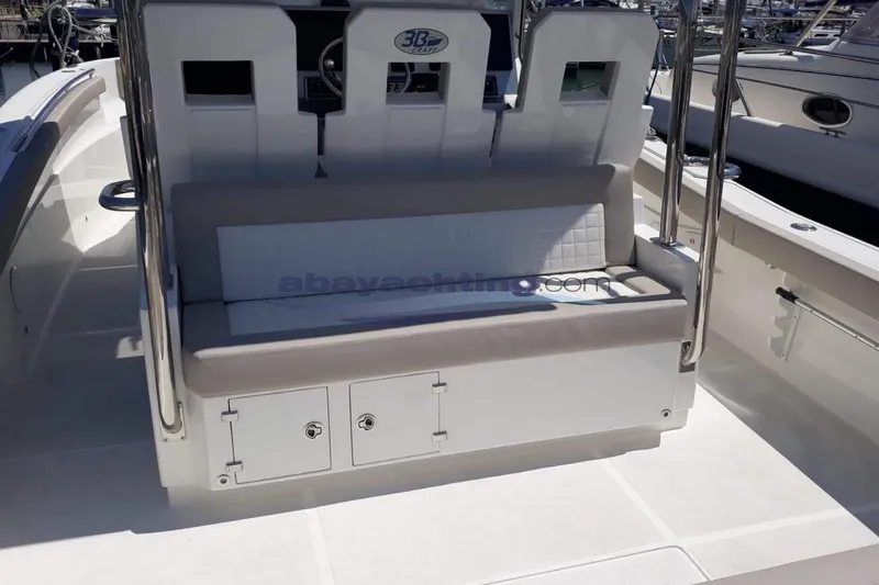  Yacht Photos Pics 2017 3B Craft 330 CC boat interior with cushioned seating and storage compartments.