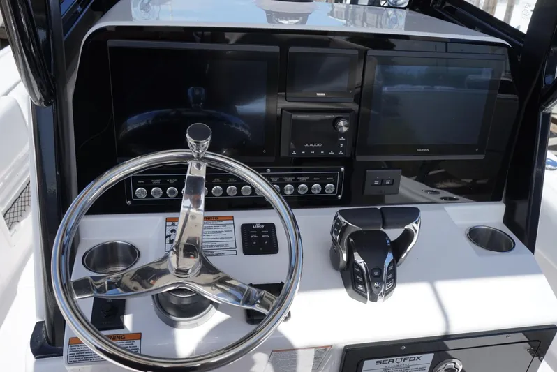  Yacht Photos Pics 2025 Sea Fox 282 Hybrid LT boat dashboard with steering wheel and electronic controls.