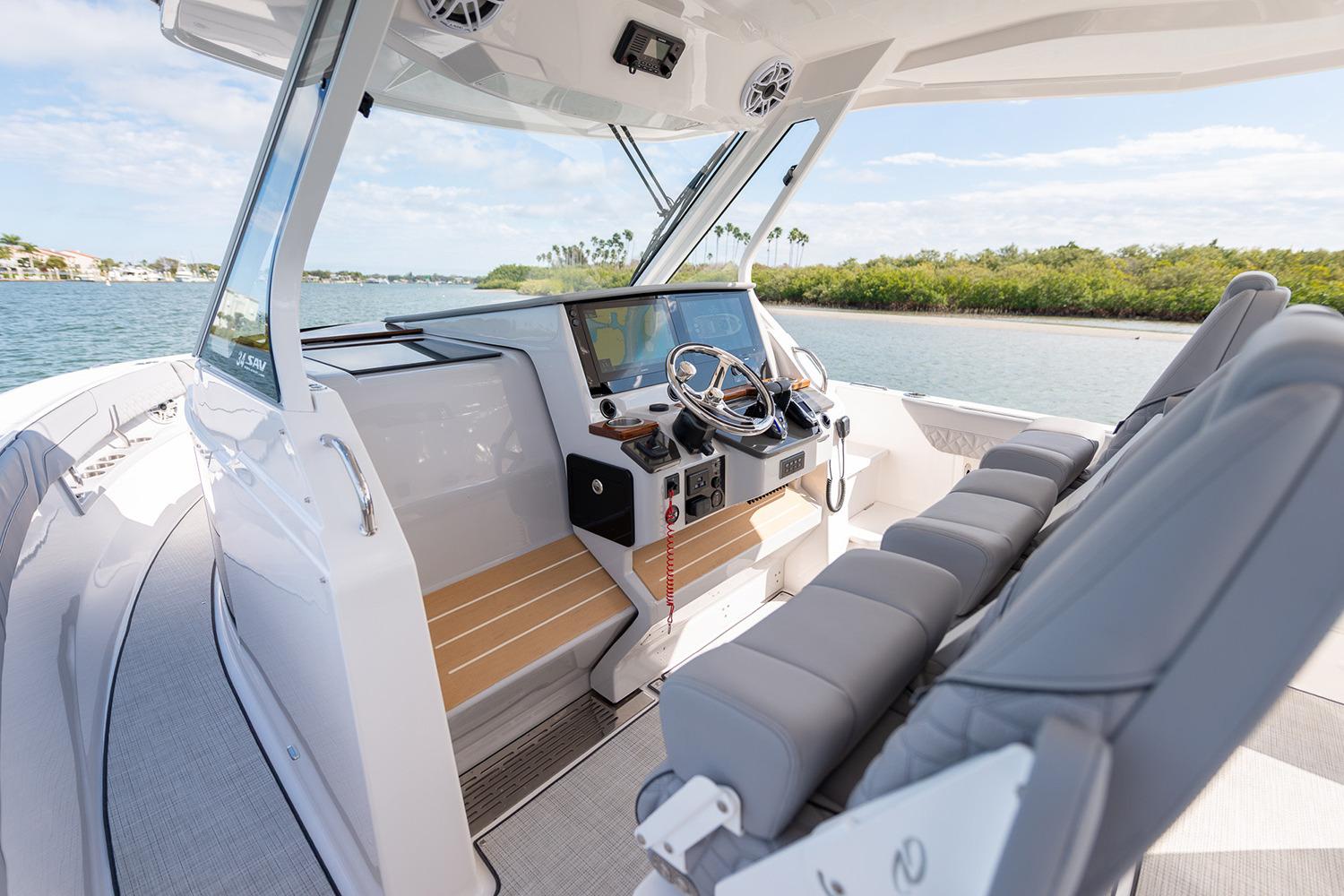 Manufacturer Provided Image: 2026 Regal 34 SAV boat interior with modern helm, plush seating, and scenic waterway view.