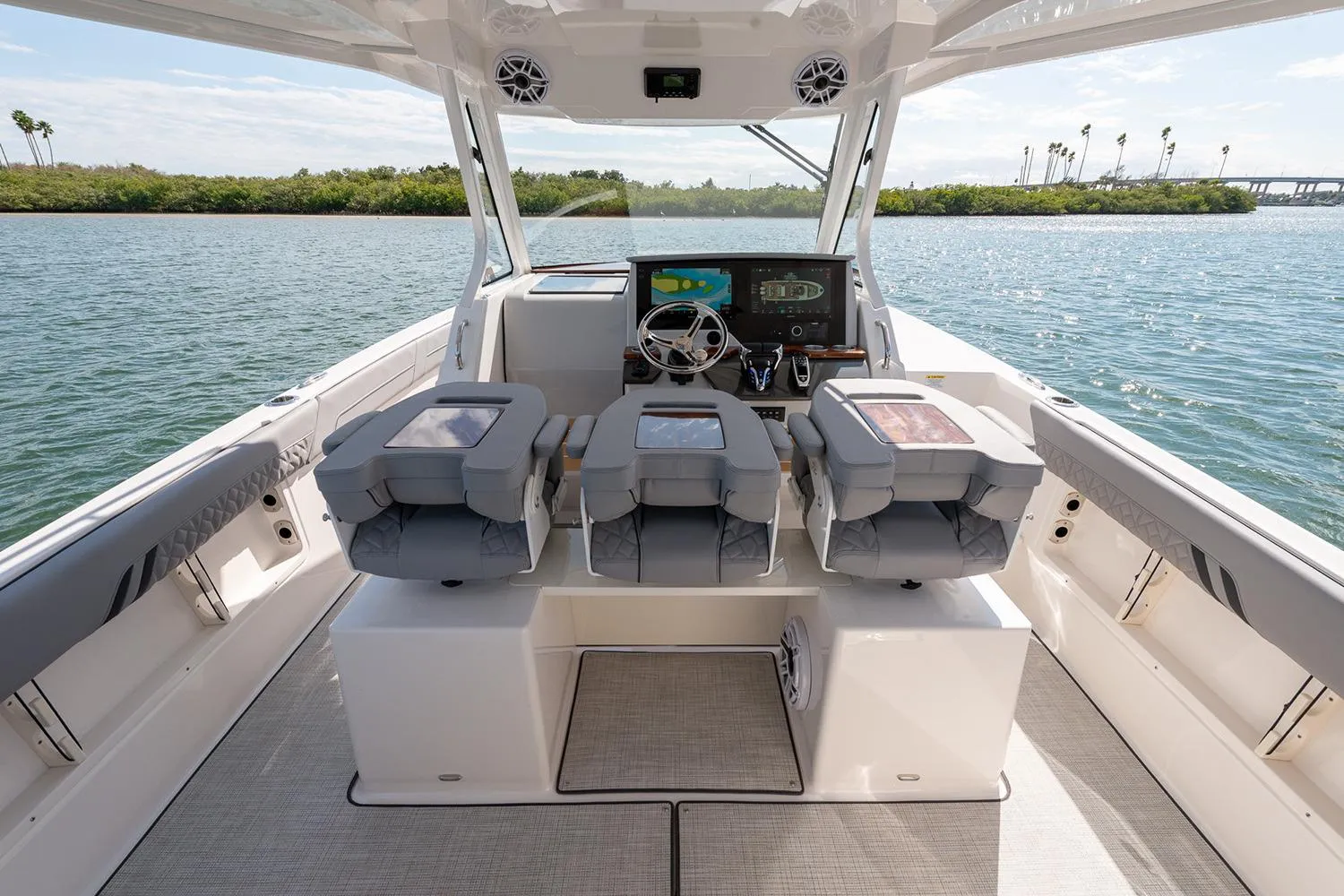 Manufacturer Provided Image: 2026 Regal 34 SAV boat interior with modern helm and seating, cruising on a sunny day.