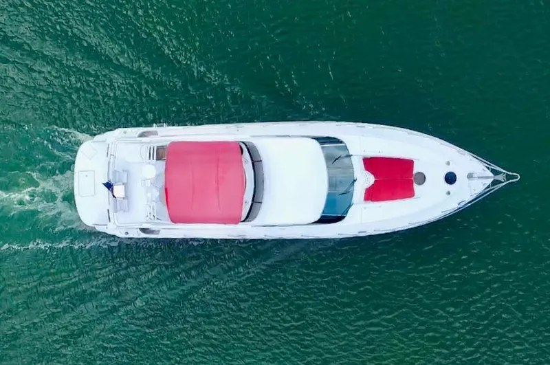 Por Fin Yacht Photos Pics Aerial view of a 1999 Fairline Squadron 65 yacht cruising on the water.