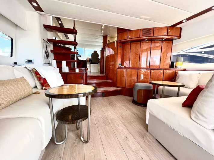 Por Fin Yacht Photos Pics Luxurious interior of 1999 Fairline Squadron 65 yacht with modern furnishings and wooden accents.