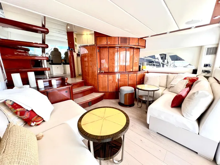 Por Fin Yacht Photos Pics Luxurious interior of 1999 Fairline Squadron 65 yacht with elegant seating and wooden finishes.