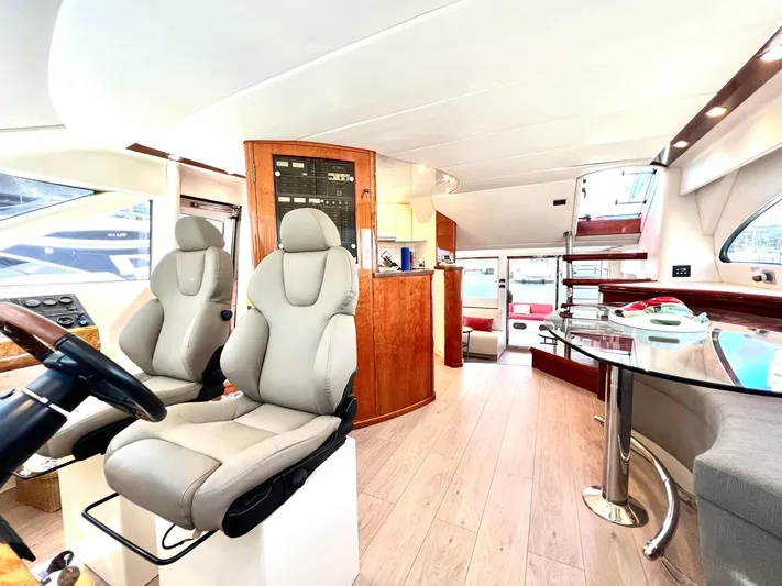 Por Fin Yacht Photos Pics Interior of 1999 Fairline Squadron 65 yacht with modern seating and dining area.