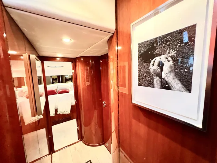 Por Fin Yacht Photos Pics Interior hallway of 1999 Fairline Squadron 65 yacht with framed artwork.