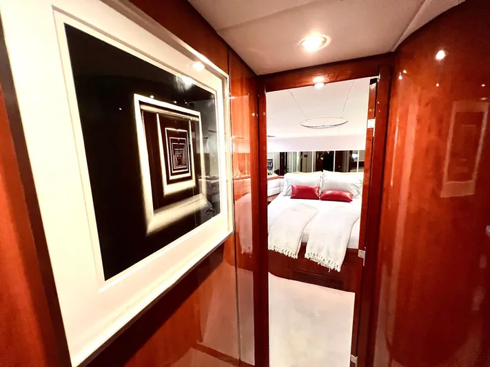 Por Fin Yacht Photos Pics Luxurious interior of 1999 Fairline Squadron 65 yacht with modern artwork and cozy bedroom.