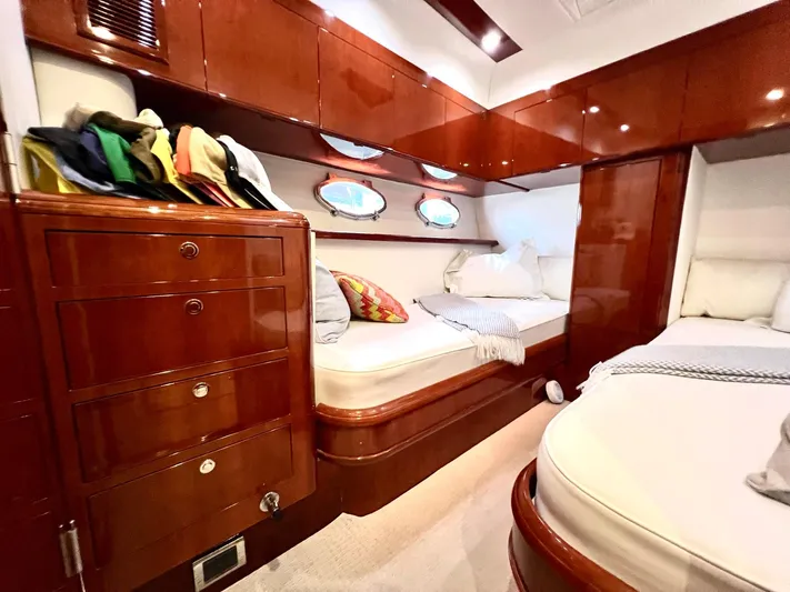 Por Fin Yacht Photos Pics Luxurious cabin interior of 1999 Fairline Squadron 65 yacht with wooden cabinetry and twin beds.