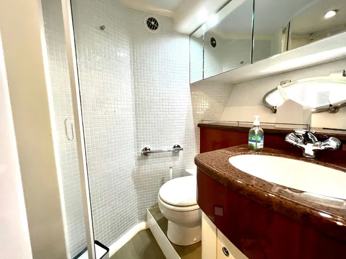 Por Fin Yacht Photos Pics Luxurious bathroom in 1999 Fairline Squadron 65 yacht with modern fixtures and glass shower.