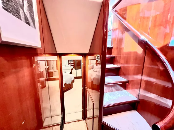 Por Fin Yacht Photos Pics Interior of 1999 Fairline Squadron 65 yacht with wooden stairs and bedroom view.