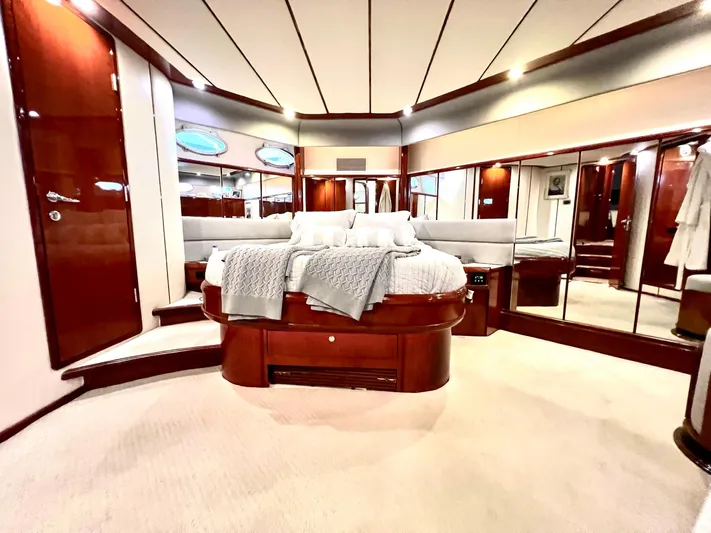 Por Fin Yacht Photos Pics Luxurious master bedroom on a 1999 Fairline Squadron 65 yacht with elegant wood finishes.