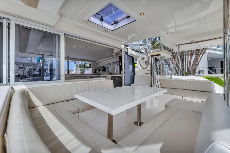  Yacht Photos Pics Luxurious interior of 2017 Leopard 40 catamaran with white seating and dining area.