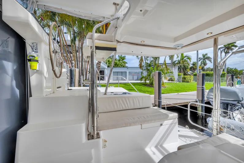  Yacht Photos Pics Leopard 40 catamaran interior, 2017 model, featuring seating and helm station near dock.