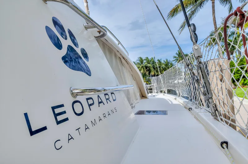  Yacht Photos Pics Leopard 40 catamaran, 2017 model, docked with palm trees in the background.