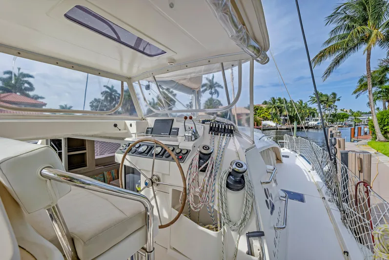  Yacht Photos Pics 2017 Leopard 40 yacht cockpit with steering wheel, navigation controls, and tropical waterfront view.