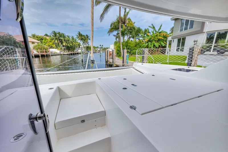  Yacht Photos Pics Leopard 40 catamaran deck with waterfront view, surrounded by tropical greenery, 2017 model.
