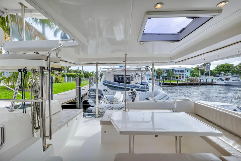  Yacht Photos Pics 2017 Leopard 40 yacht interior with seating area, table, and marina view.