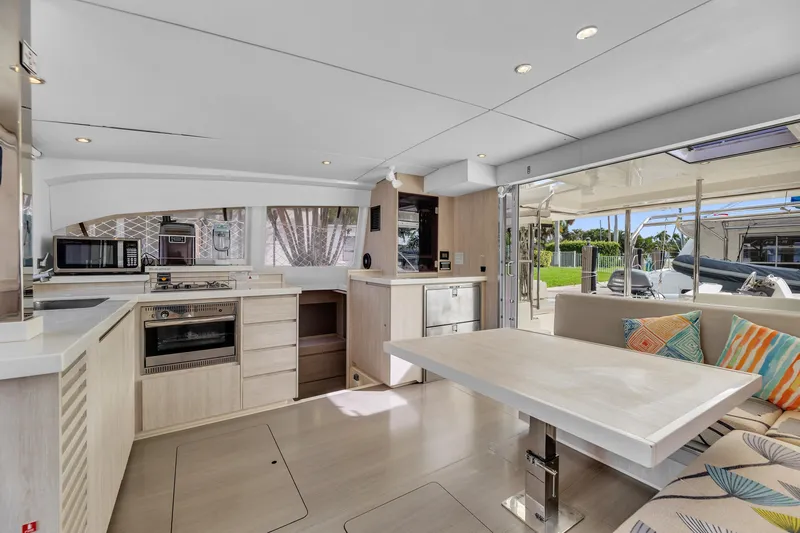  Yacht Photos Pics Modern interior of 2017 Leopard 40 catamaran with kitchen and dining area.