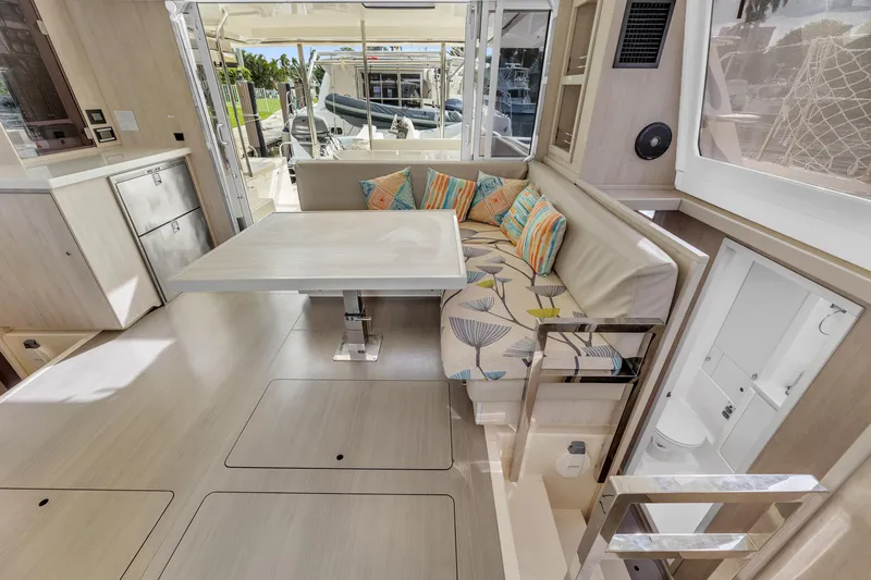  Yacht Photos Pics Modern interior of 2017 Leopard 40 catamaran with dining area and colorful cushions.