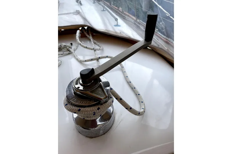 Begonia Yacht Photos Pics Winch handle on 1988 Custom Atkin & Lange Cutter sailboat, with rope coiled around.