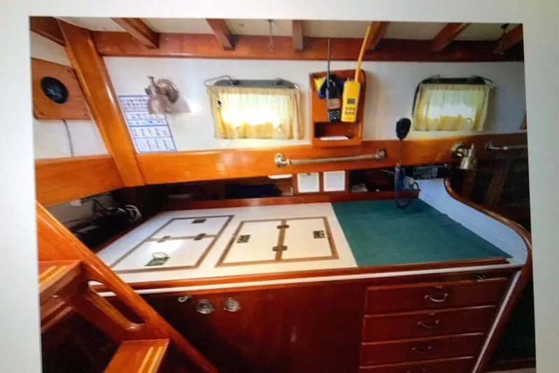 Begonia Yacht Photos Pics Interior of 1988 Custom Atkin & Lange Cutter with wooden cabinetry and navigation equipment.