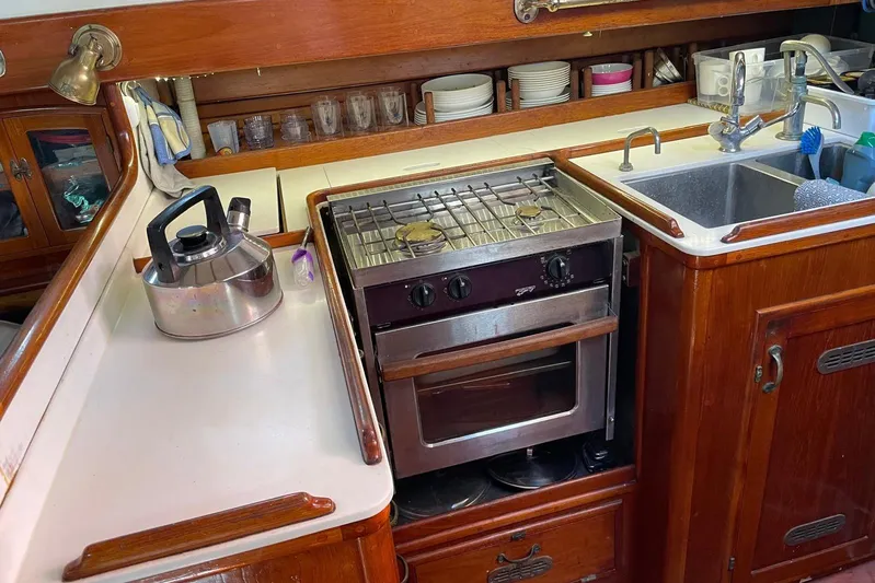 Begonia Yacht Photos Pics Cozy boat kitchen with stove, sink, and kettle; Atkin & Lange Cutter, 1988.