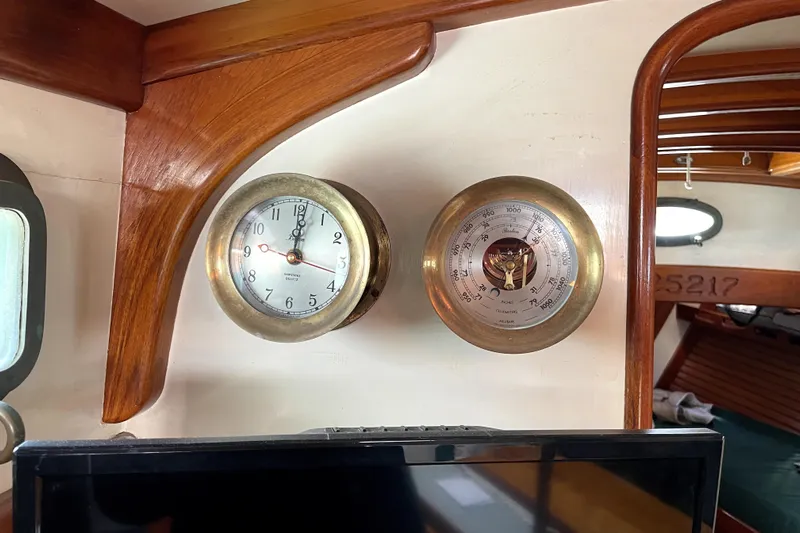 Begonia Yacht Photos Pics Brass clock and barometer on 1988 Atkin & Lange Cutter's wooden interior.