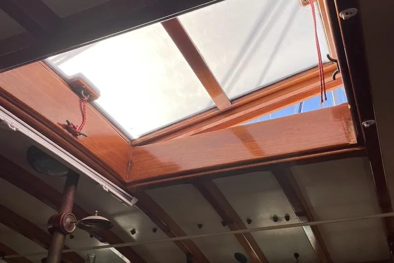 Begonia Yacht Photos Pics Wooden hatch of 1988 Custom Atkin & Lange Cutter, open to blue sky.