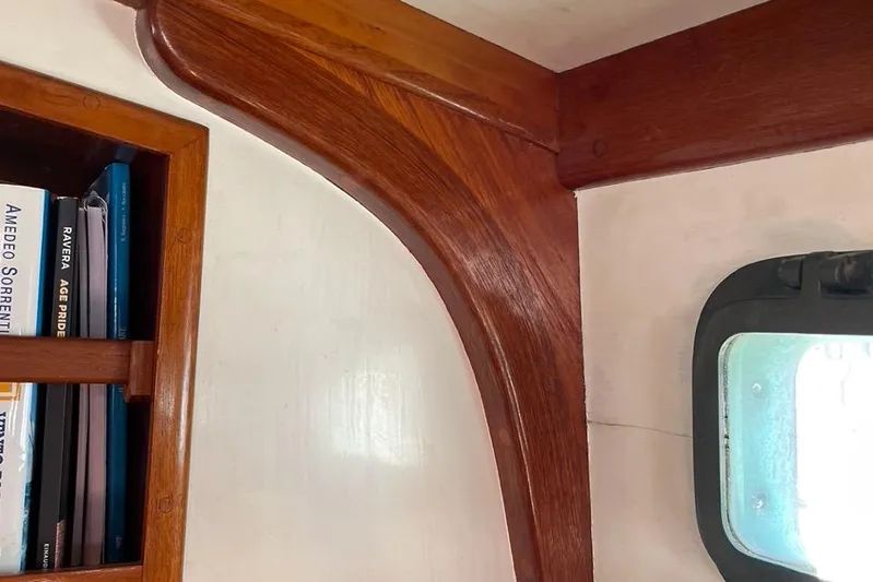 Begonia Yacht Photos Pics Interior of 1988 Custom Atkin & Lange Cutter with wooden trim and bookshelf.