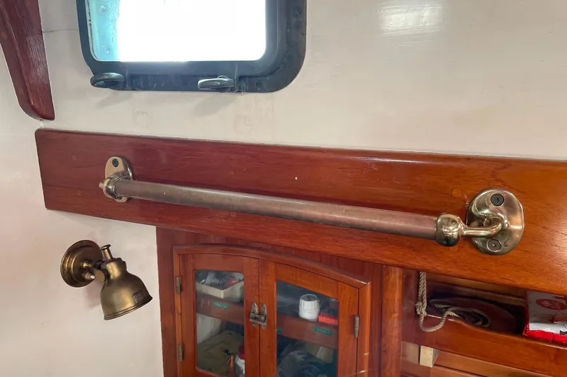 Begonia Yacht Photos Pics Interior of 1988 Custom Atkin & Lange Cutter with brass fixtures and wooden cabinetry.