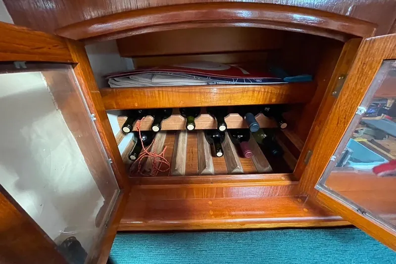 Begonia Yacht Photos Pics Wooden cabinet with wine bottles inside, part of a 1988 Custom Atkin & Lange Cutter.
