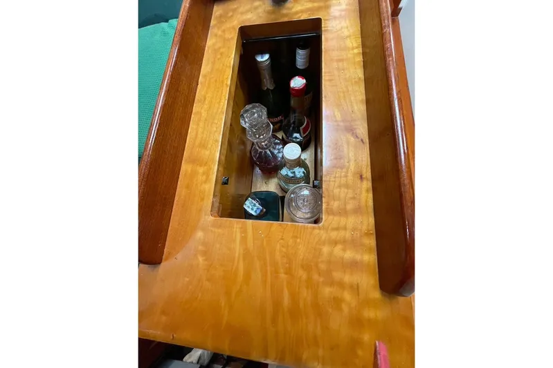 Begonia Yacht Photos Pics Wooden compartment on 1988 Custom Atkin & Lange Cutter, storing various bottles and decanter.