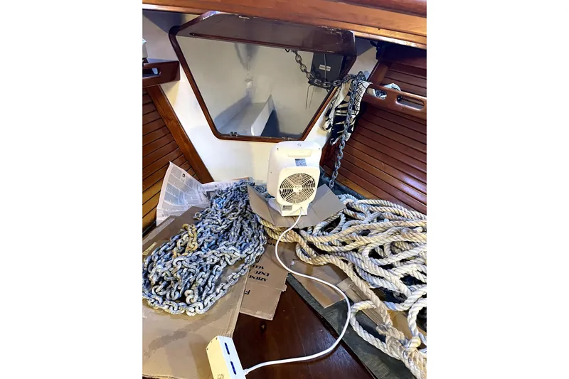 Begonia Yacht Photos Pics Interior of 1988 Custom Atkin & Lange Cutter with ropes, chains, and a small fan.