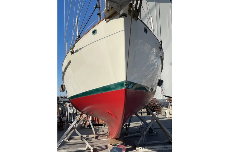 Begonia Yacht Photos Pics Custom 1988 Atkin & Lange Cutter sailboat on dry dock, showcasing red and white hull.