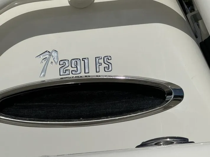  Yacht Photos Pics 2025 Key West 291 FS boat emblem on white surface.