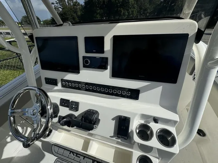  Yacht Photos Pics 2025 Key West 291 FS boat dashboard with dual screens and steering wheel.