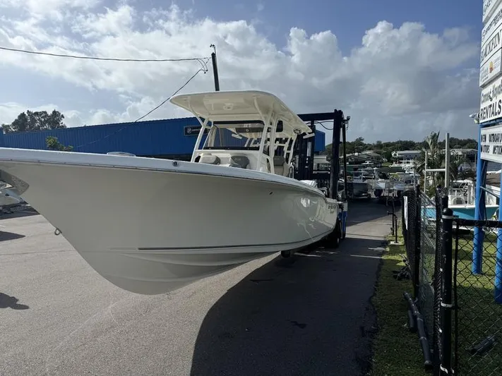  Yacht Photos Pics 2025 Key West 291 FS boat on trailer at marina under cloudy sky.