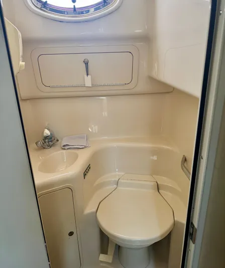 Los Sue&Ntilde;os Yacht Photos Pics Bathroom interior of 1999 Sea Ray 400 Sundancer yacht, featuring compact toilet and sink.