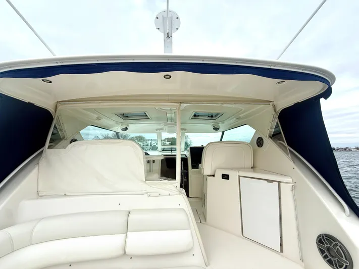 Relentless Yacht Photos Pics 2006 Tiara Yachts 4300 Sovran interior with white seating and blue accents on the water.