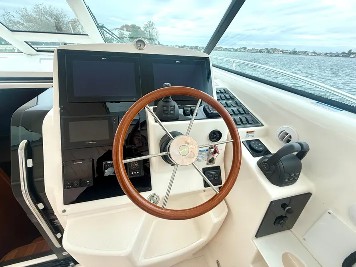 Relentless Yacht Photos Pics Helm of 2006 Tiara Yachts 4300 Sovran with wooden steering wheel and navigation controls.